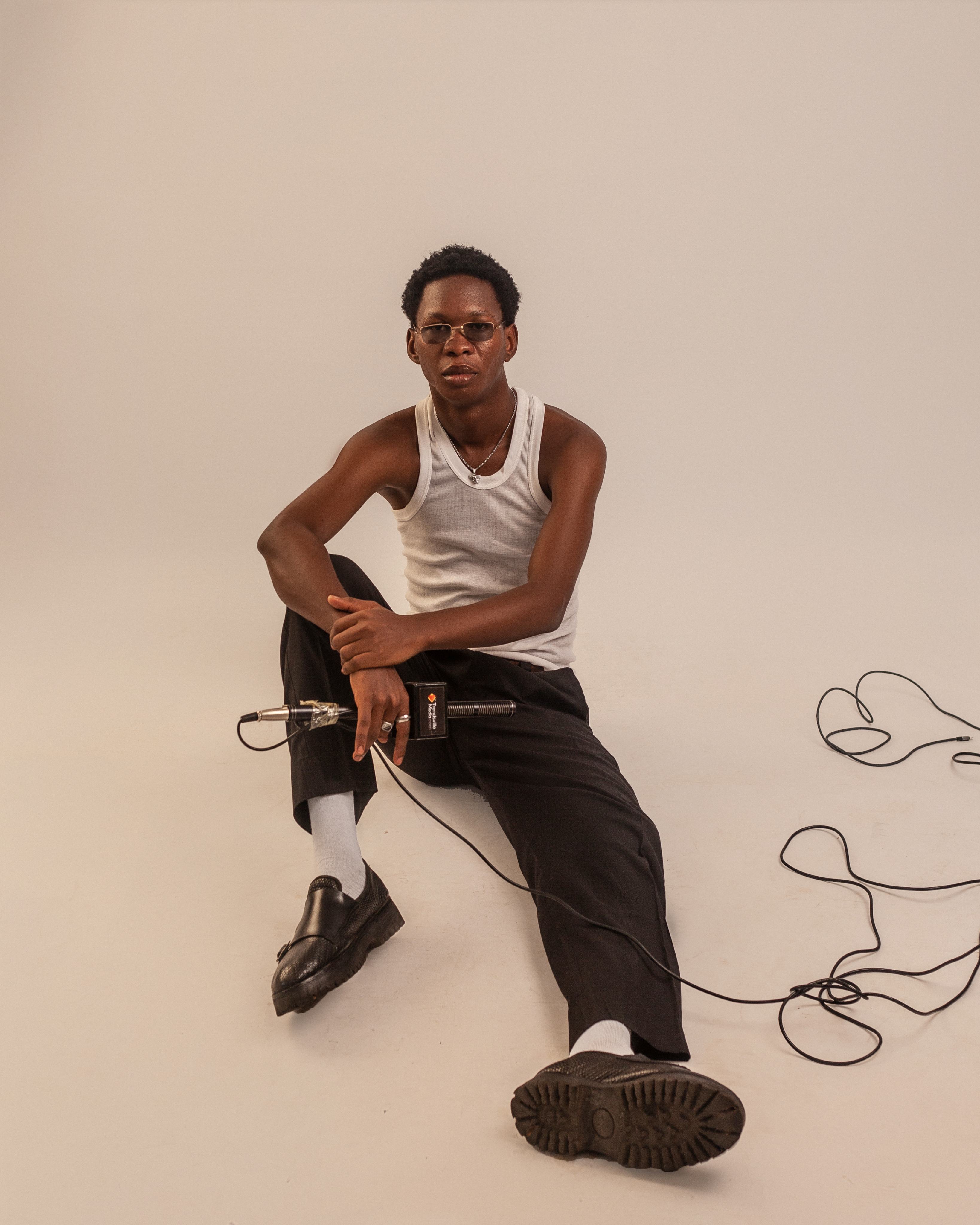 Muyii seated with microphone